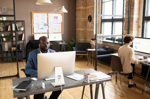 Preview: Colleagues working on computers at office