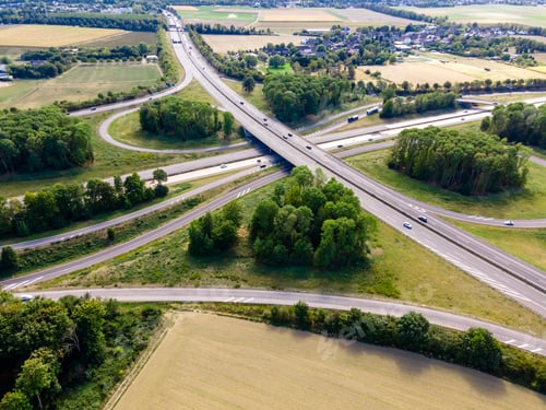 Preview: Top view of cars driving on round intersection in city. Aerial view of road in Germany