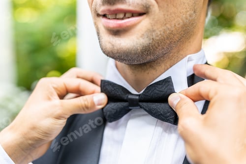 Preview: Man Adjusting his Black Bow Tie