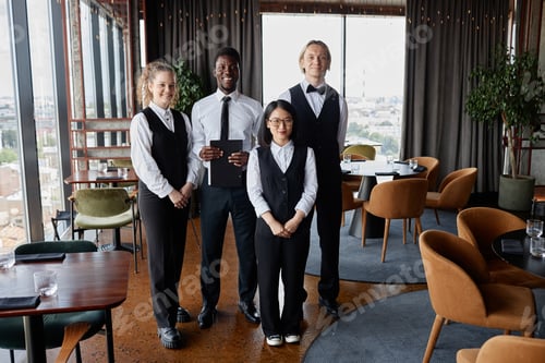 Preview: Restaurant staff with servers wearing classic black and white uniforms