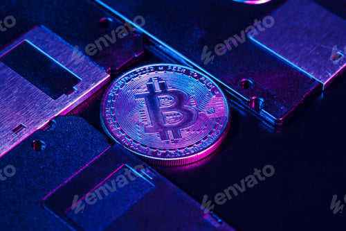 Preview: golden bitcoin on floppy disk. Close up