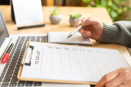 Preview: Person checking completed tasks on a to do list