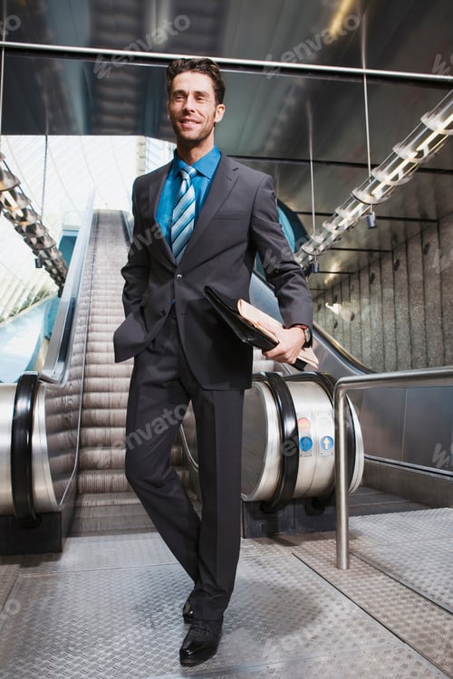 Preview: Germany, Bavaria, Munich, Business at subway station, escalator in background