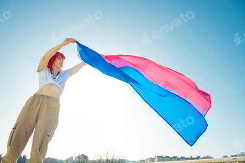 Preview: Beautiful shot of a red hair female waving blue and red flag