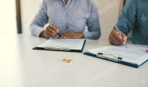 Preview: Husband and wife crate signing divorce documents at lawyer office.