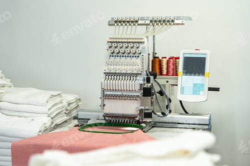 Preview: Close up of embroidery machine making patterns on textiles