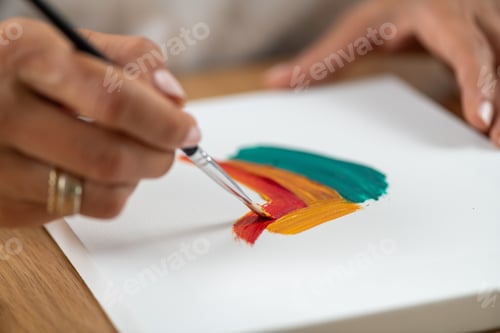 Preview: Woman painting at home using simple craft tools.