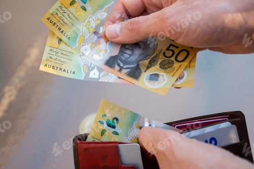 Preview: Hands holding wallet with australian dollars and make a payment