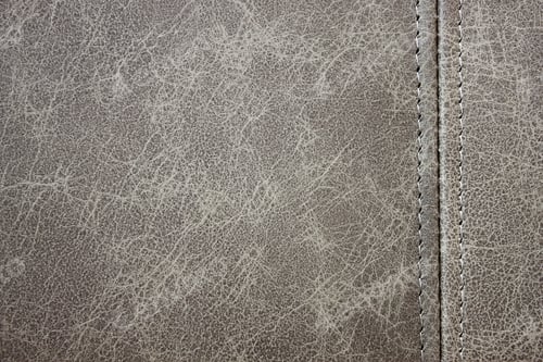 Preview: Texture gray leather with a vertical decorative seam, closeup background