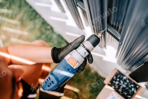 Preview: construction worker working with an electric screwdriver on the construction site