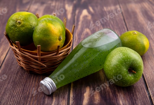 Preview: front view juice bottle with tangerines in basket and apple on wooden background
