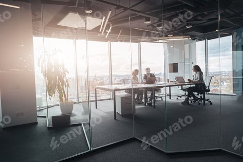 Preview: Creative business people working on project in modern office with panoramic view