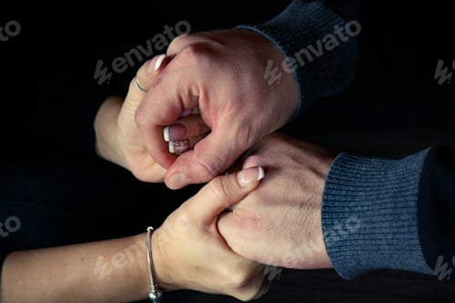 Preview: Male and female hands holding affectionately