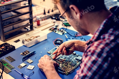 Preview: Technicians working on computer mainboard