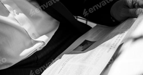 Preview: Man reading newspaper