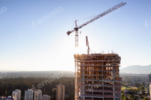 Preview: Aerial view of a residential building construction site during a vibrant summer sunset