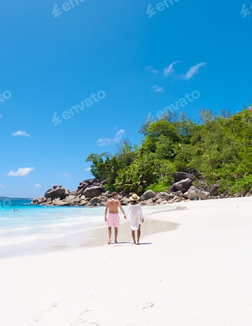 Preview: Anse Lazio Praslin Seychelles, a young couple of men and women on a tropical beach during vacation