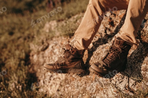 Preview: Anonymous traveler resting on rock