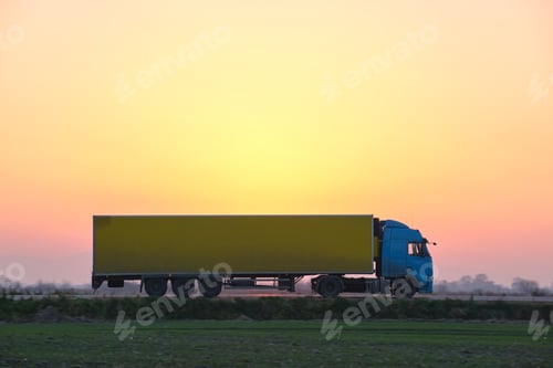 Preview: Semi-truck with cargo trailer driving on highway hauling goods in evening. Delivery transportation