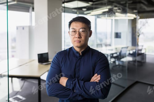 Preview: Portrait of asian businessman inside modern office, boss in glasses serious looking at camera, man
