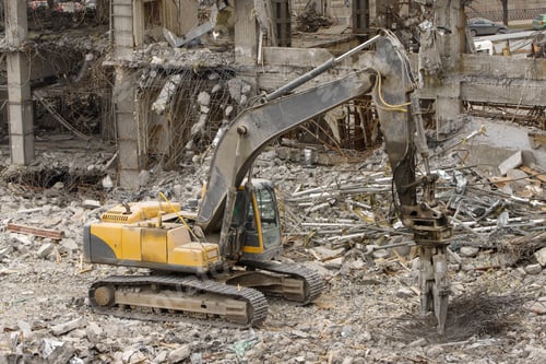 Preview: Hydraulic scissor excavator sorts scrap metal at construction site