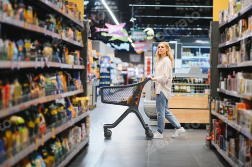 Preview: Young woman doing grocery shopping at the supermarket