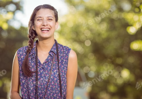 Preview: Pretty hipster smiling at camera on a summers day