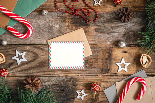 Preview: Blank postcard, envelope and Christmas decor on wooden background, copy space.