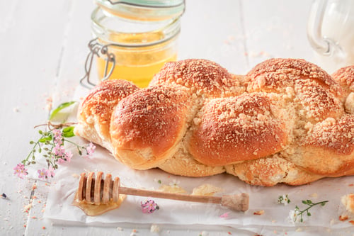 Preview: Hot golden challah baked in a home bakery.