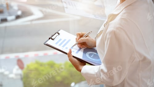 Preview: Cropped image, Businesswoman taking notes on business paperwork