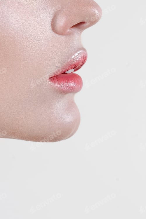 Preview: Lips and chin of young sensual woman with clear glowing skin closeup in profile