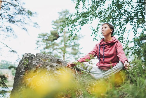 Young smiling woman practice yoga outdoors