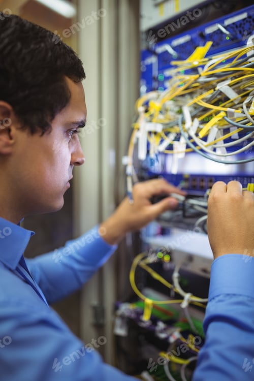 Preview: Technician Checking Cables In A Rack Mounted Server In Server Room