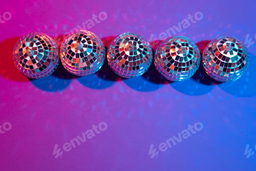 Preview: disco ball shines on purple background close up