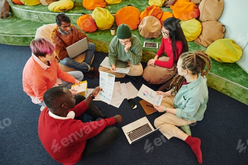 Preview: Group of intercultural financial managers brainstorming and discussing papers