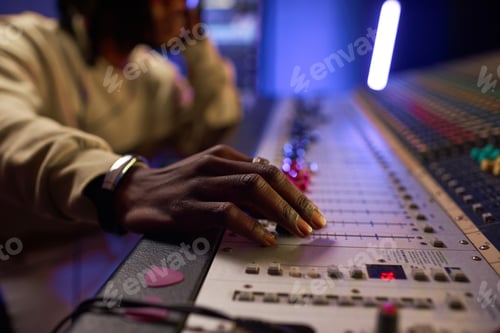 Preview: Sound Engineer Mixing Music on a Soundboard