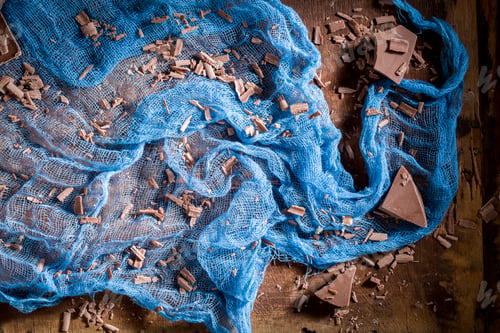 Preview: Brown and blue background with chocolate bar and textile