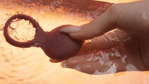 Preview: Close up of new modern sex toy vibrating underwater in female hand. Creative. Concept of