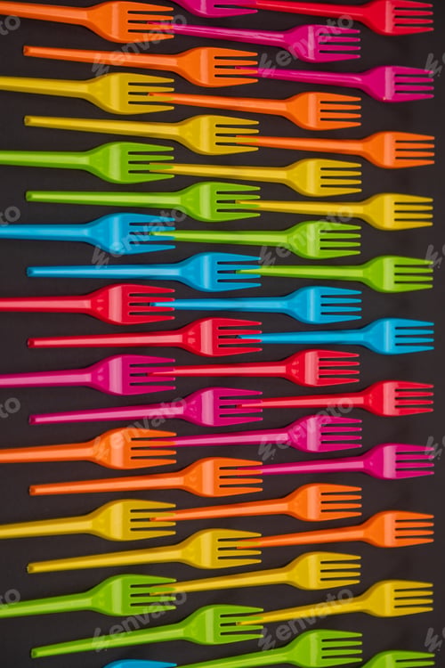 Preview: Many color plastic forks on a bright background