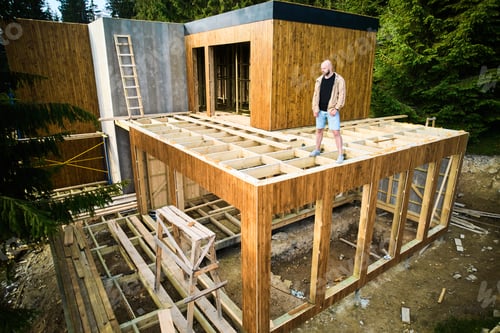 Preview: Carpenter constructing wooden frame house.