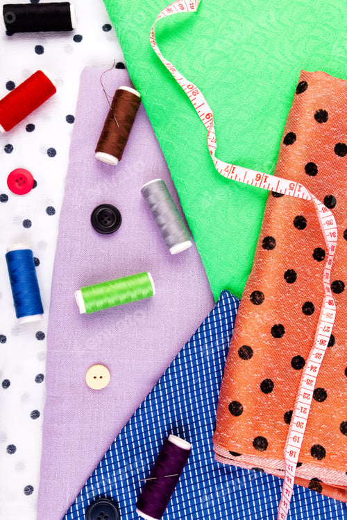 Preview: Items for sewing clothes. Sewing buttons, spools of thread and cloth. Top view.