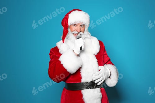 Preview: Santa Claus singing into microphone on color background. Christmas music