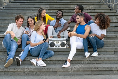 Preview: Young multiracial friends having fun listening music with boombox stereo and using mobile smartphone