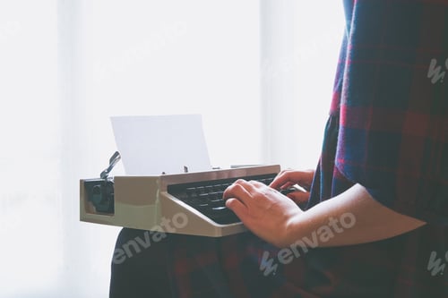 Preview: Girls hands typing in vintage typewriter