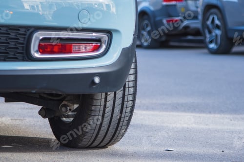 Preview: Close-up of car tires and wheel parked on asphalt roads.