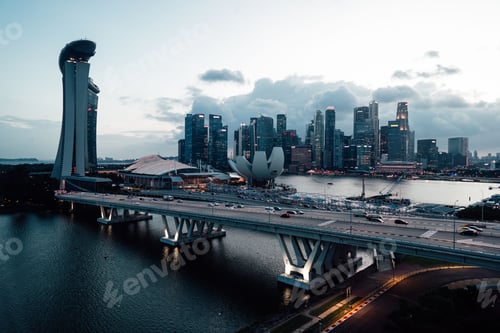 Preview: Aerial view of Marina Bay Sands and the Singapore skyline at dusk with the Helix Bridge