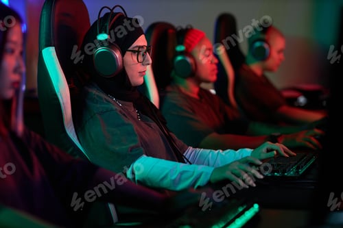 Preview: Muslim Woman Playing Video Games with Team in Cybersports Club