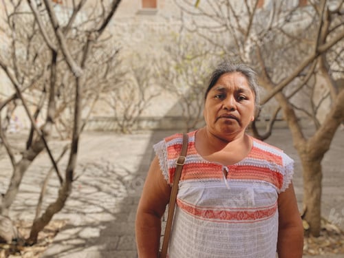 Preview: Woman Standing in an Urban Courtyard with Trees