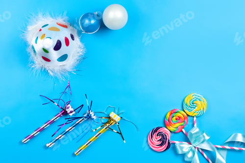 Preview: a top view colorful celebration details colorful lollipops birthday cap balloons on the blue