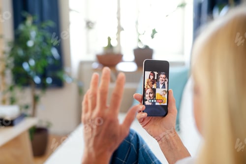 Preview: Senior businesswoman with smartphone indoors in home office, business call concept